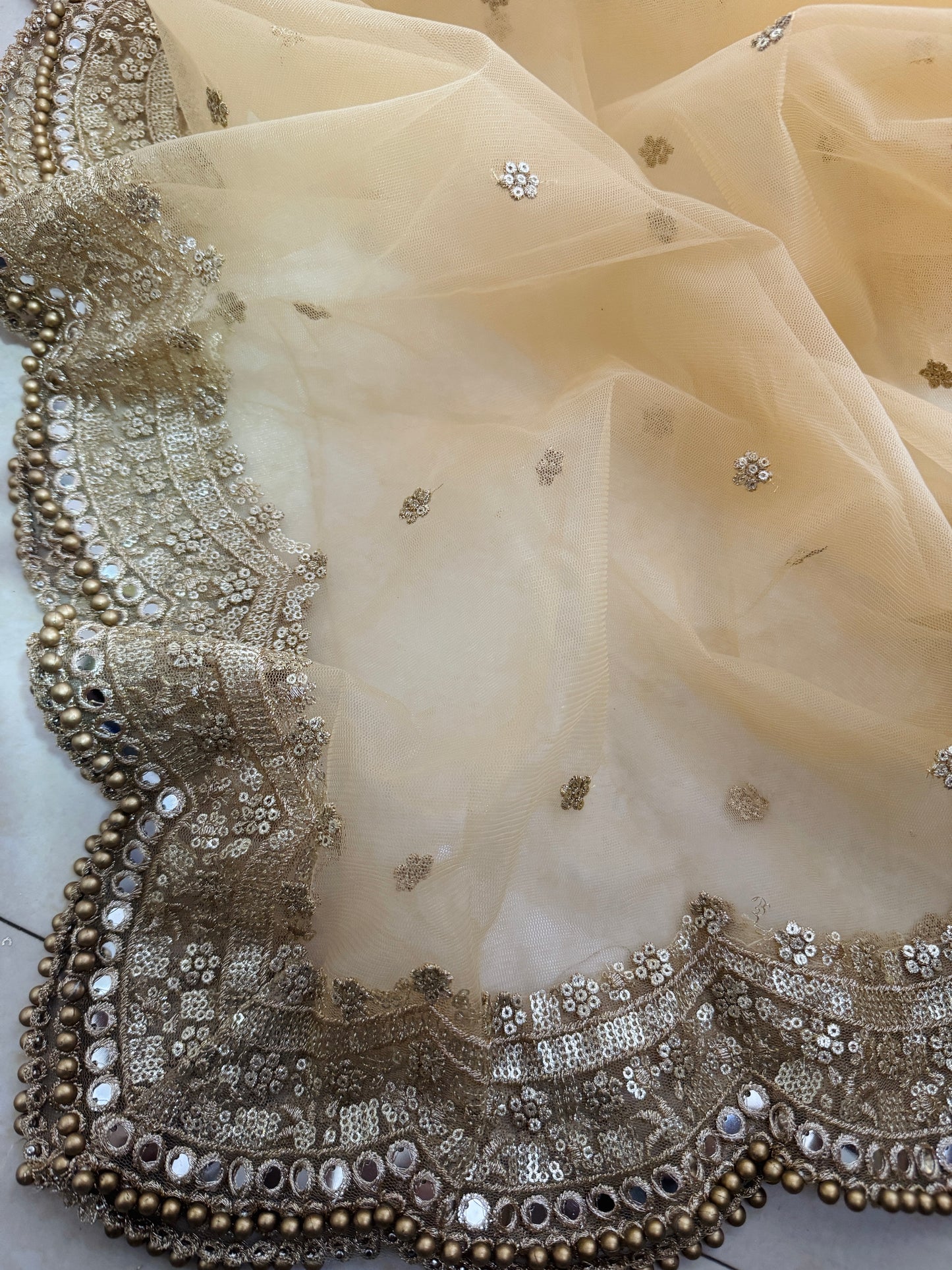Mirror and zari embroidery details on golden bridal dupatta